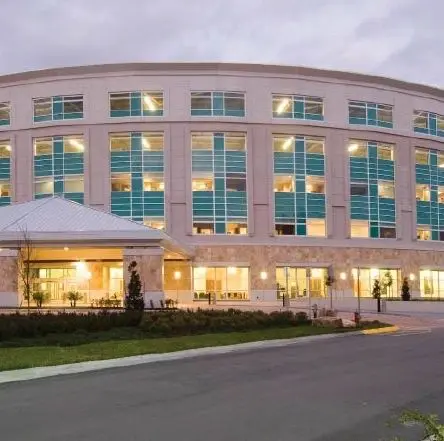 A large building with many windows and lights on it