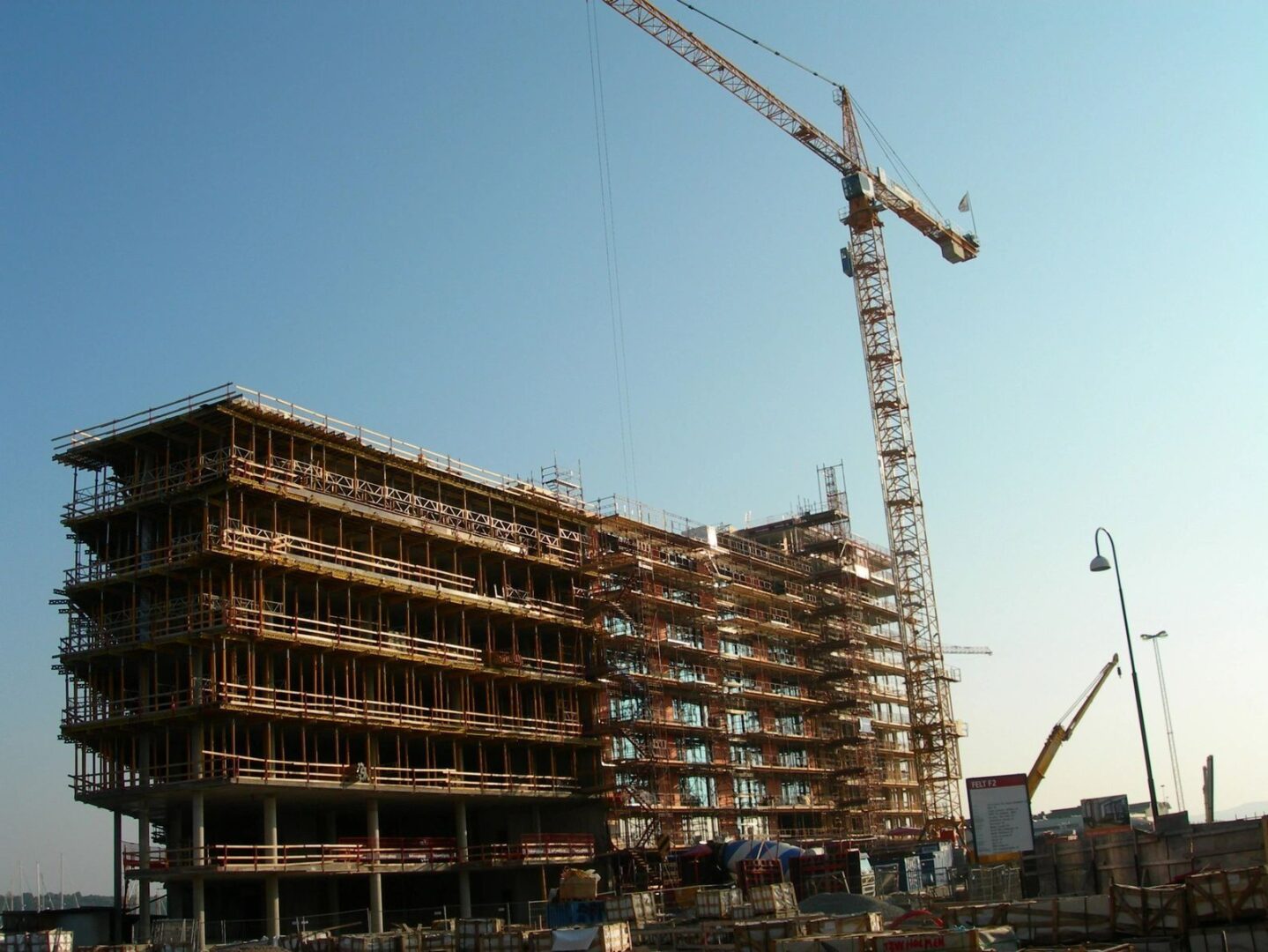 A building under construction with a crane in the background.