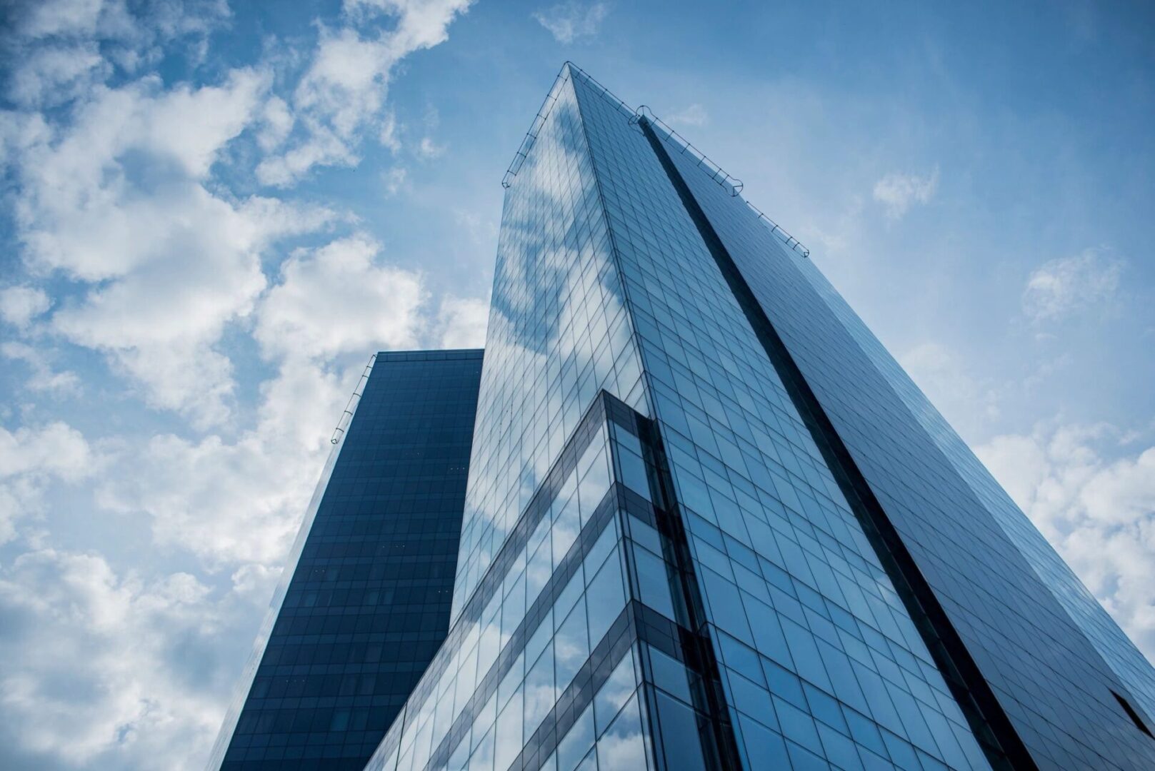 A tall building with two windows and a sky background