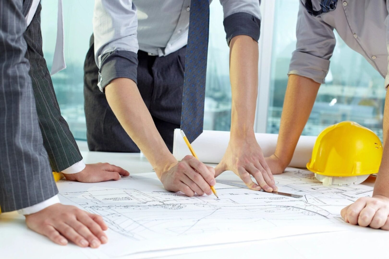 A group of people working on plans at a table.