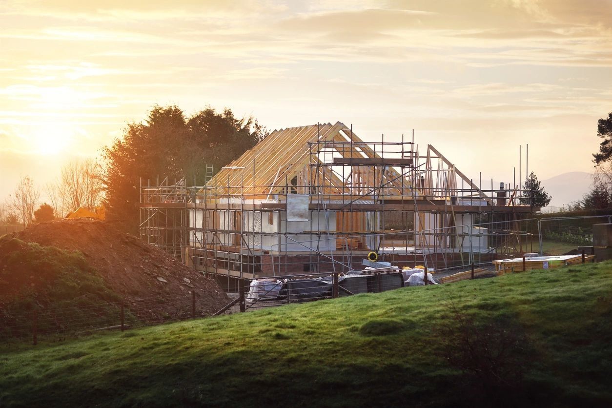 A house under construction with scaffolding on top of it.