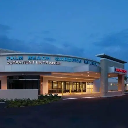 A large building with a lit up sign on the front.