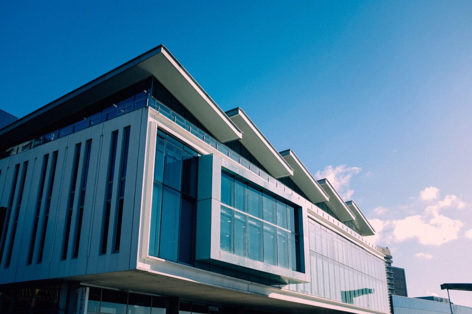 A building with many windows and some glass on the outside.