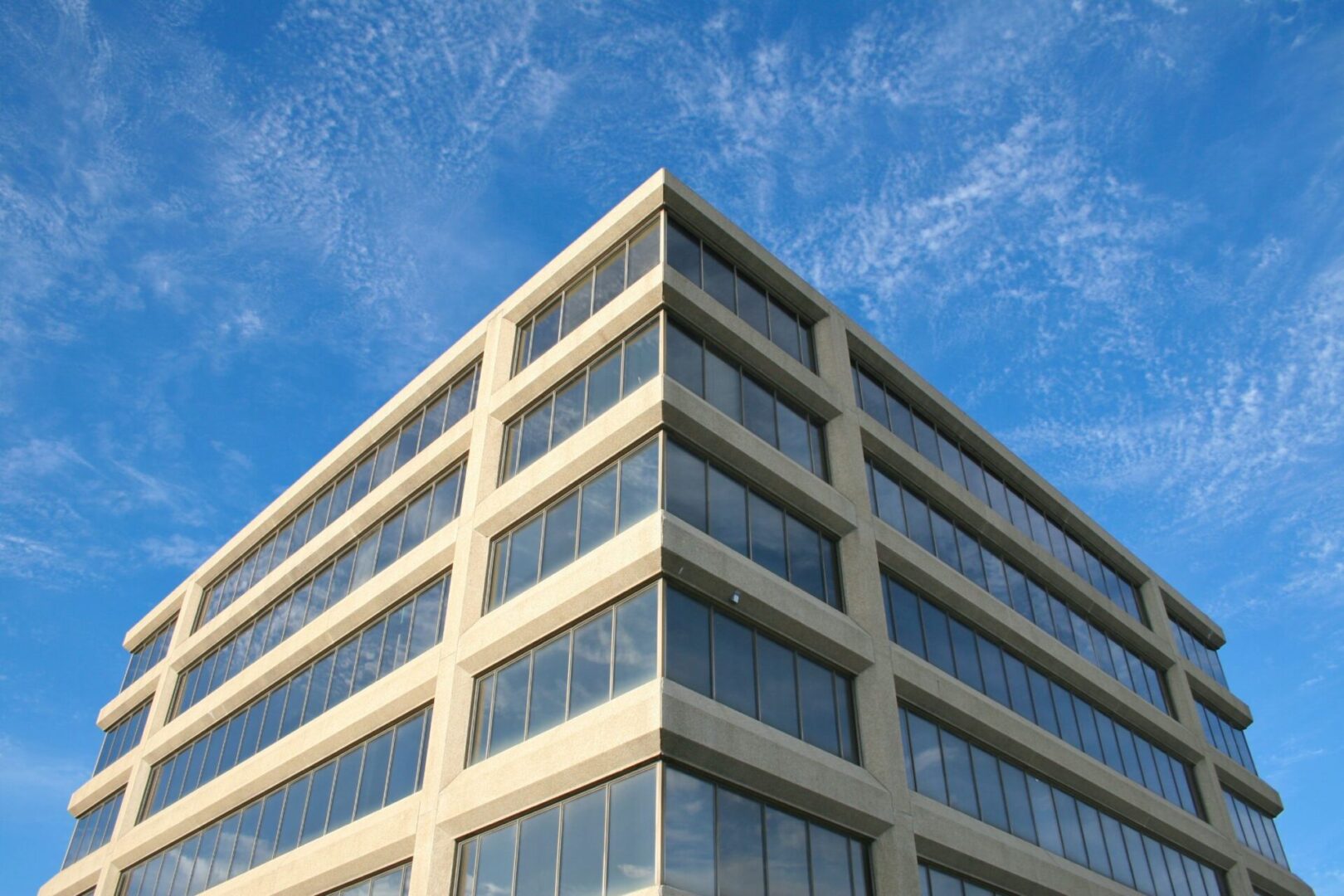 A building with many windows and a sky background