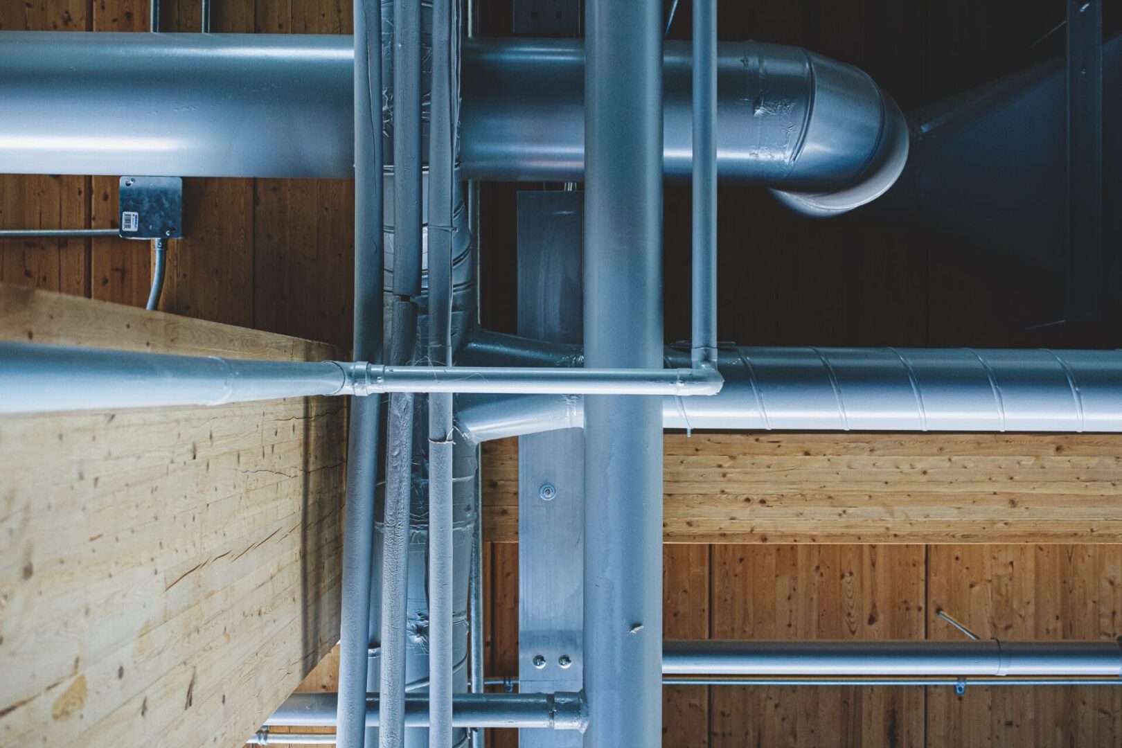 A close up of pipes on the side of a building