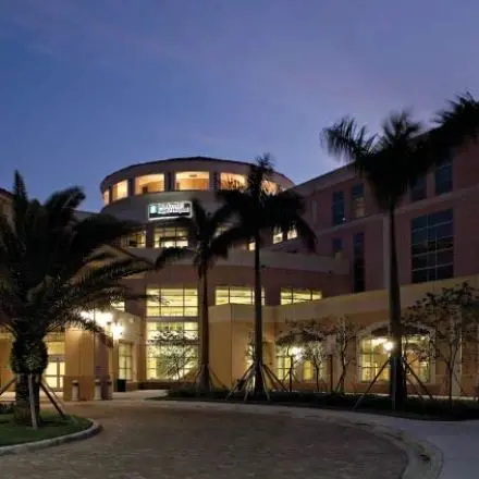 A building with palm trees in front of it