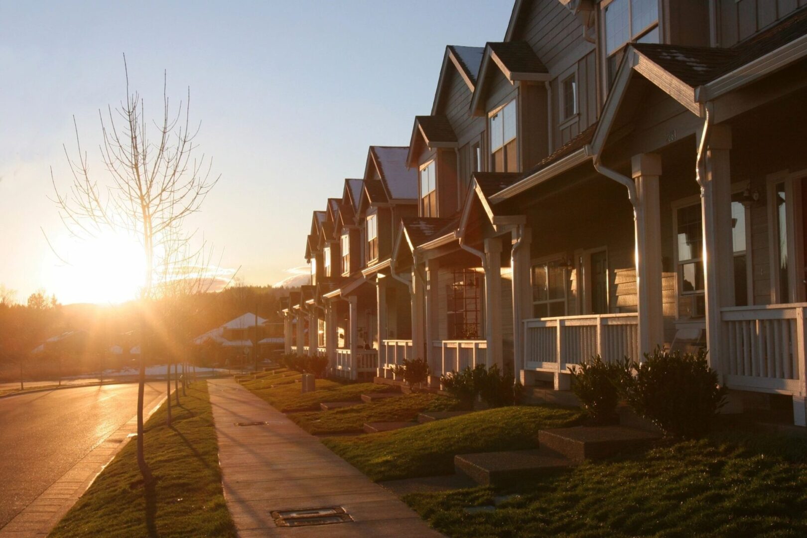 A row of houses on the side of a street.