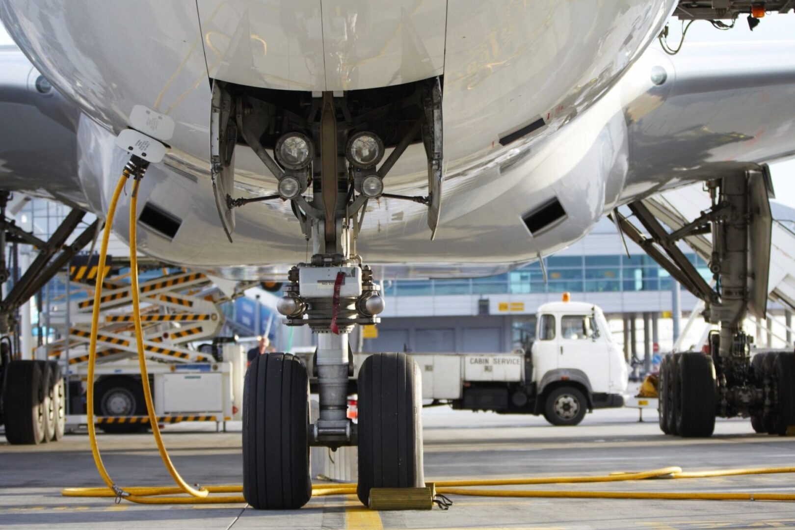 A man standing next to an airplane on the tarmac.